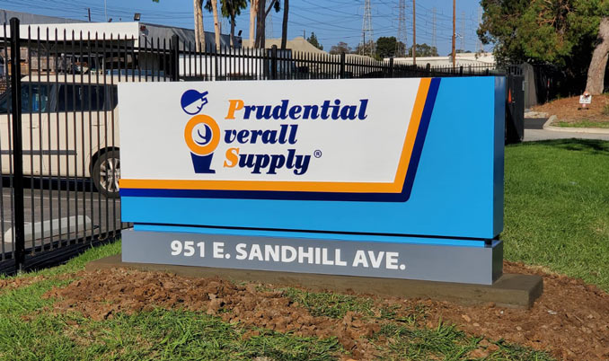 Custom monument sign for Prudential Overall Supply at 951 E. Sandhill Ave., Ontario, CA, featuring company logo, bold blue and orange branding, and street address on a durable base, fabricated and installed by Innovative Sign Systems.