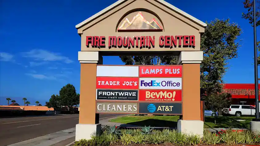 Faux monument sign for Fire Mountain Center with customized tenant directory for diverse retail businesses.