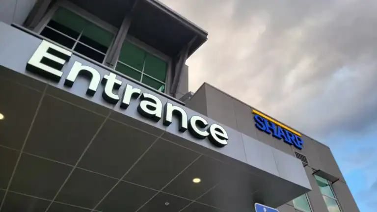 SHARP Medical Center Channel Letters Signage Illuminated channel letter signs for "Entrance" and "SHARP" on a modern medical building in San Diego, CA.