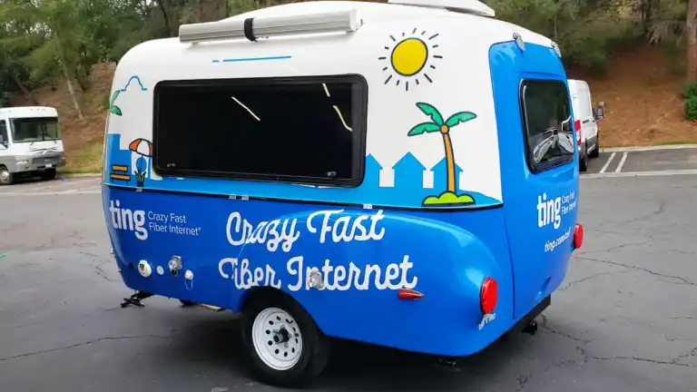 Bright blue and white Ting Fiber Internet trailer wrap by Innovative Sign Systems parked in Encinitas