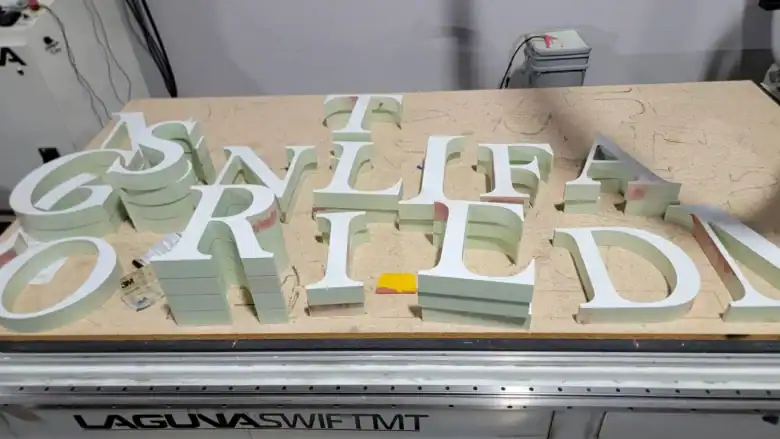 Precision CNC routing of 3D HDU dimensional letters on a Laguna Swift table in a Vista, CA sign shop.