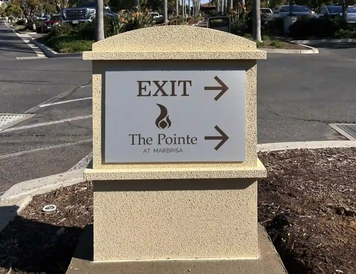 Custom aluminum exterior wayfinding monument sign with "Exit" directional arrow.
