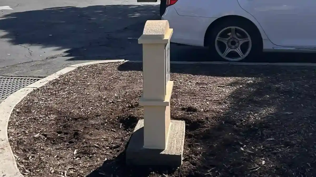 Side view of a textured aluminum monument sign base and panel installation.